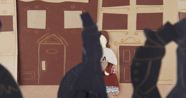 Kadr z filmu animowanego, ciemne sylwetki postaci znajdują się na pierwszym planie, a w tle widoczna jest jasna postać stojąca przed budynkiem.