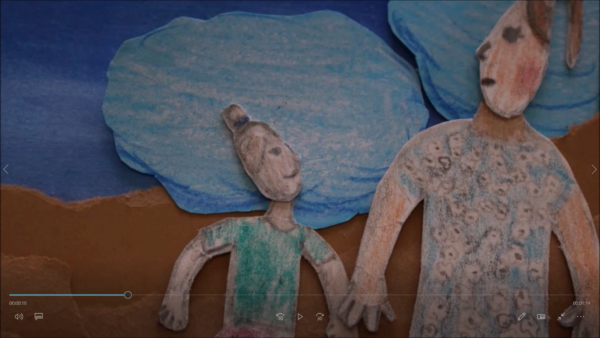 Kadr z filmu animowanego, dwie papierowe postacie trzymają się za ręce na tle niebieskiego nieba i stylizowanych chmur.