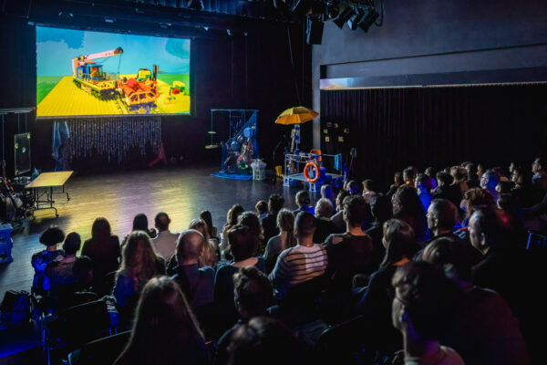 widownia siedzi na sali i ogląda film na kinowym ekranie