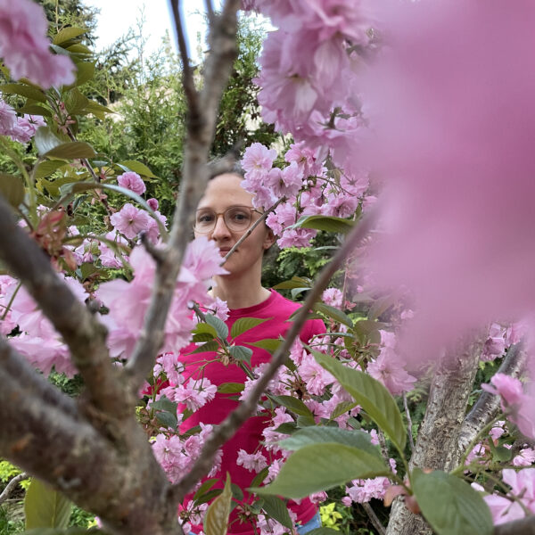 portret kobiety na tle różowych kwiatów